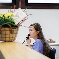 Een persoon die aan een bureau zit te telefoneren.