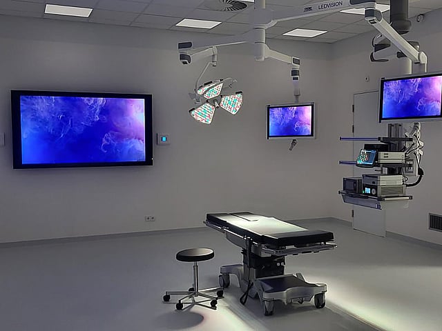 Een kamer met een bed en een televisie en een monitor.